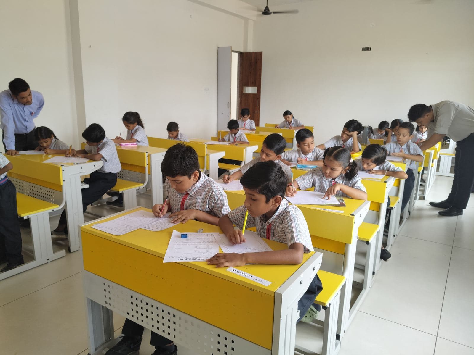 Young students at their desks in a bright classroom